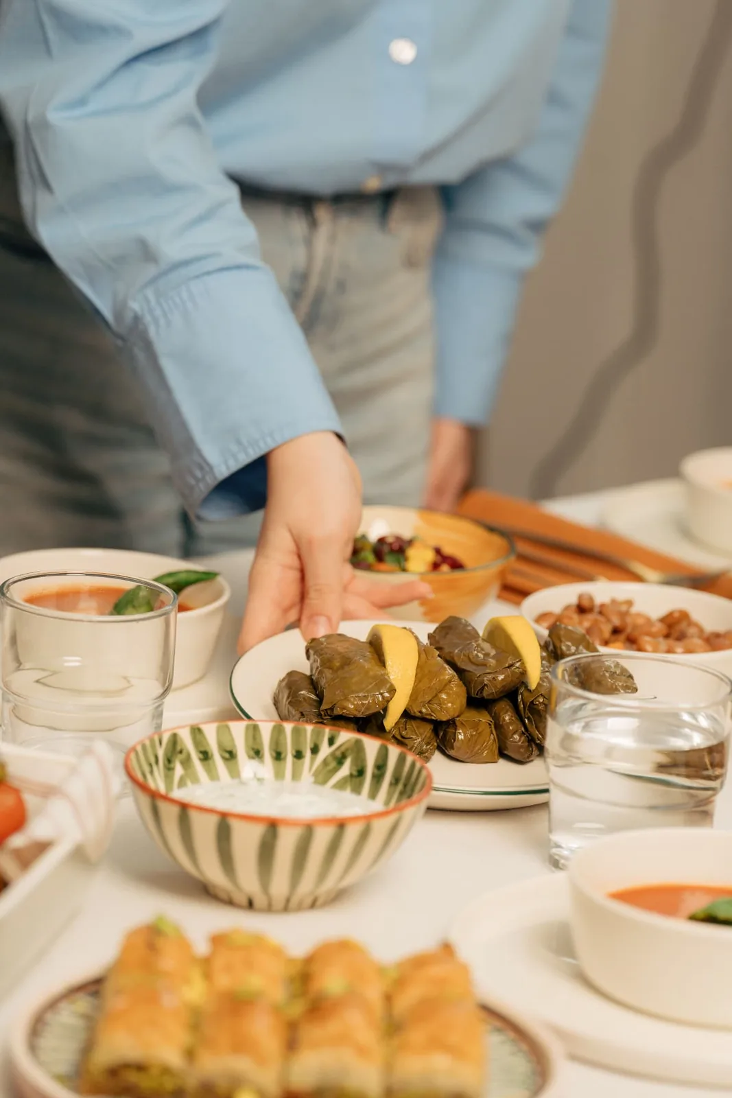 A guest serving food at a shared table