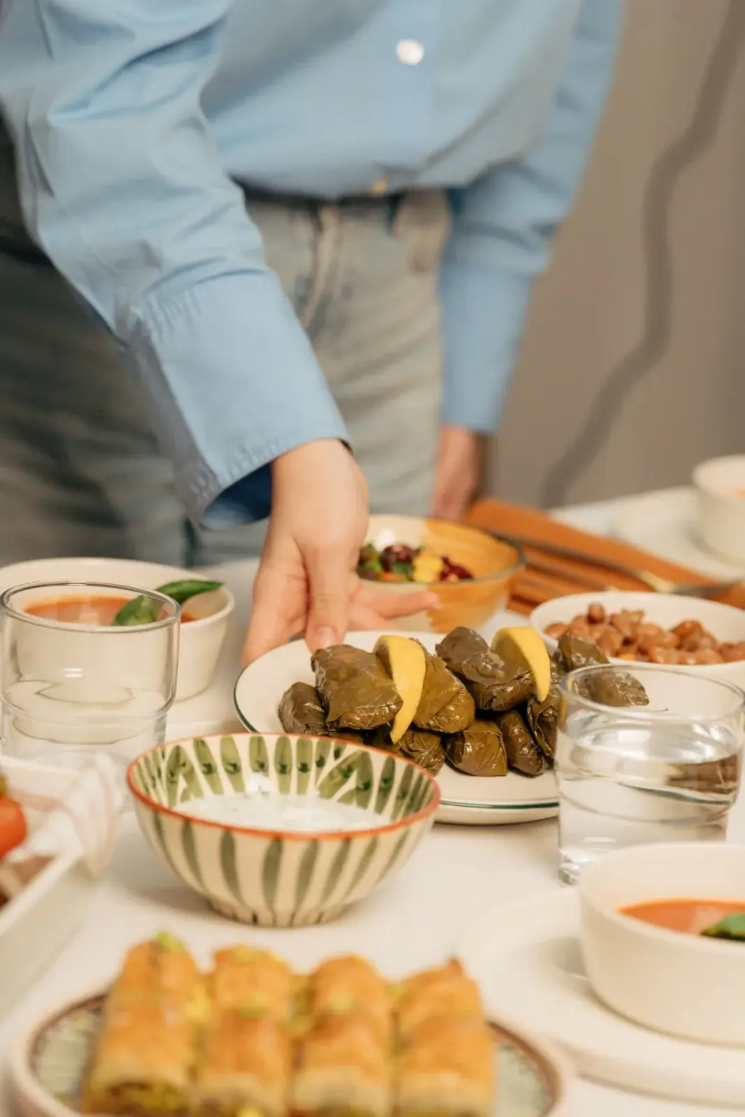 A guest serving food at a shared table