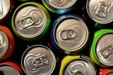 Close-up of assorted canned soft drinks.