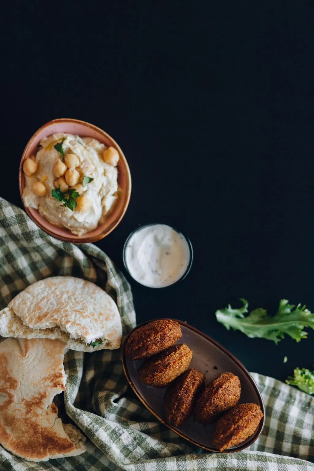 Falafel with hummus, pita bread and dipping sauce.