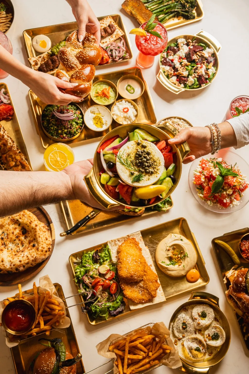 People sharing dishes around a Mediterranean-style table.